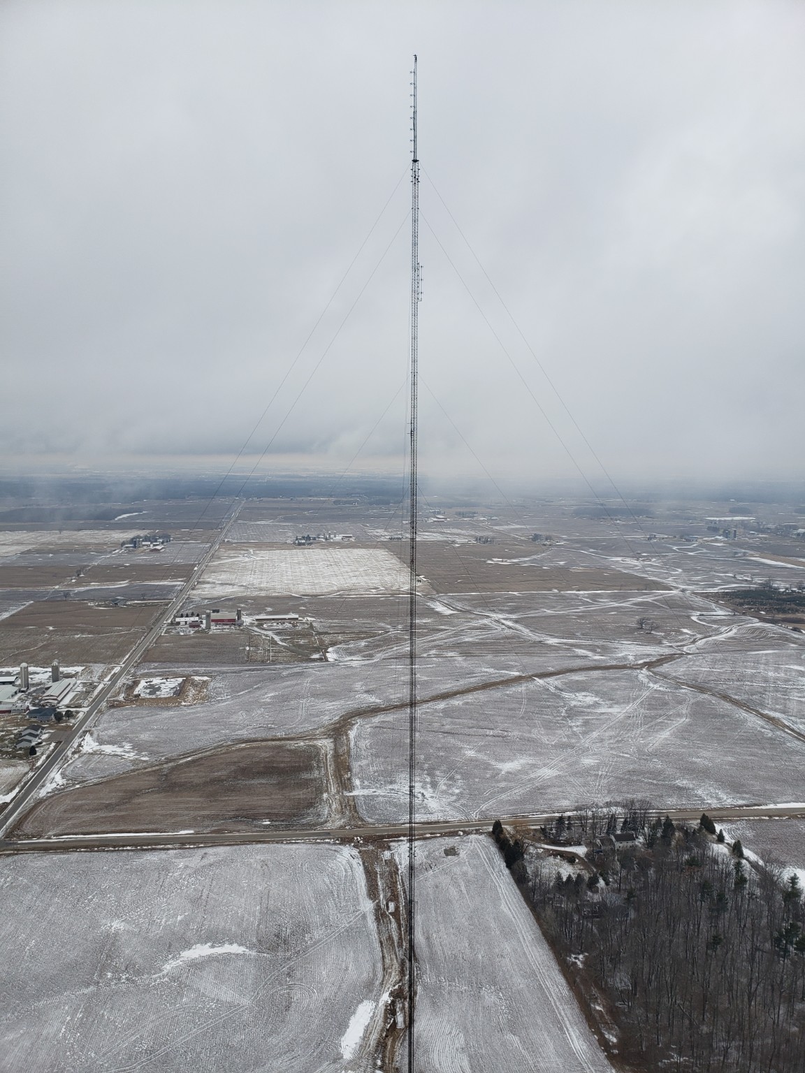 Tower climber working on an iced communications tower